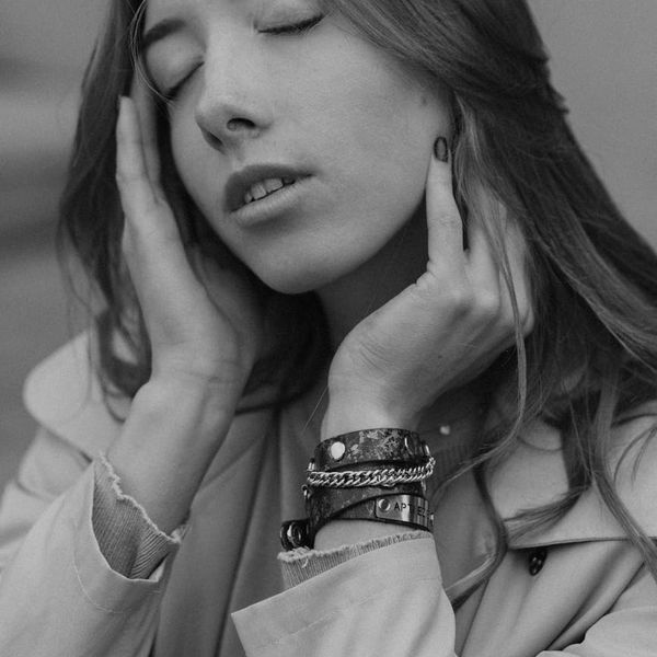 Person meditating peacefully in a minimalist setting with soft light.